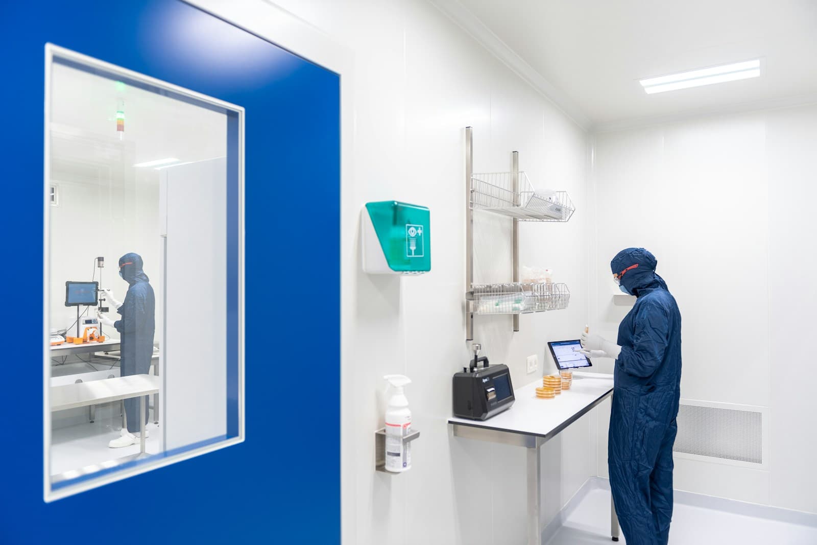 Clean-room technician reviewing controlled facility workflow data